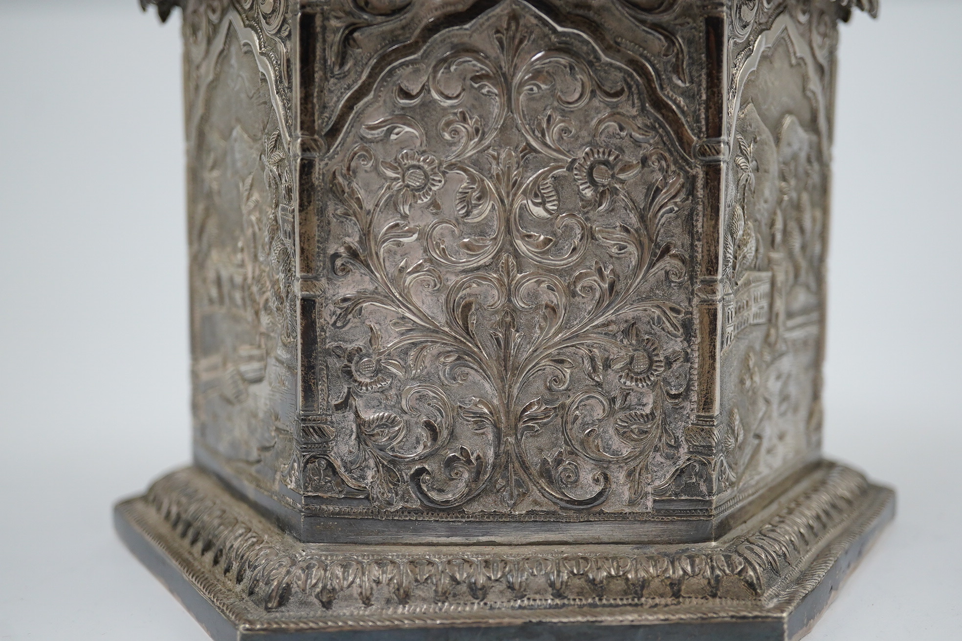 An early 20th century Indian embossed silver hexagonal box with fluted domed hinged cover